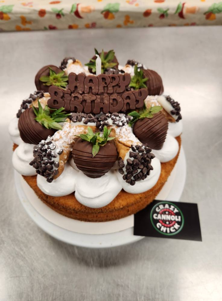 Cannoli birthday cake with chocolate dipped strawberries and mini cannoli