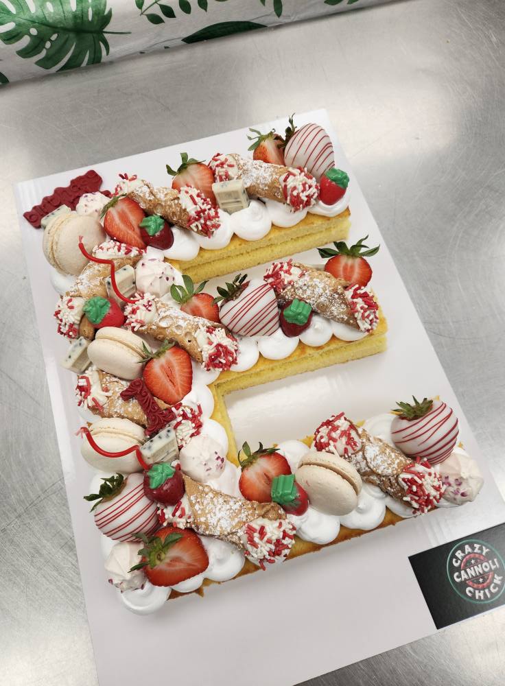 Decorated letter cake or strawberry arrangement